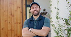 Smile, delivery and face of man at front door for courier service, distribution and shipping. Logistics, supply chain and export with person and arms crossed outdoor of home for cargo and pride