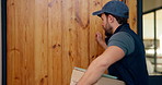 Knock, delivery and man at door with package for shipping, courier service and ecommerce order. Waiting, house and back of person with parcel, cargo and box for logistics, distribution and shipment