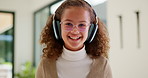 Headphones, video call and face of child in home with elearning, online class or education. Audio tech, kid and portrait of girl student with wave for greeting in virtual lesson in apartment.