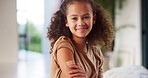 Girl, face and plaster for vaccine with smile for medicine, flu shot and healthcare at clinic. Kid, bandage and cover for injection, portrait and immune system boost for virus at hospital in Brazil