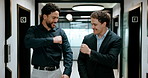Business, men and fist bump with success, deal or achievement for partnership meeting. Excited, support and professional salesman with winning, celebration and good job for teamwork in hallway