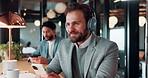Business man, phone and headphones in boardroom, smile for music or funny podcast with text message. Notification, social media and male professional in office with audio tech, happy or online joke