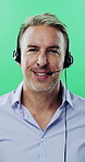 Face, man and call center agent in studio for help, technical support and customer service. Portrait, hotline and mature consultant with headset for IT assistance, smile and talk on green background