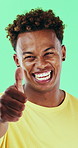 Face, man and laugh in studio with thumbs up emoji, confirmation and satisfaction for funny joke. Happy, person and hand gesture with thank you, agreement and review for humor on green background.