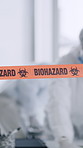Office, warning and people with biohazard tape for quarantine zone, virus outbreak and safety. Team, ppe and workers in hazmat suit for cleaning, medical crisis or disinfection for disease prevention