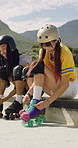 Happy, friends and woman with rollerskate laces for skating, hobby and activity in summer. Park, skater and people prepare with equipment for sports, practice skills and training on weekend outdoor