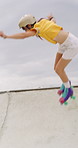 Rollerskate, jump and woman outdoor for skating, hobby or cardio with safety gear in urban skatepark. Fun, ramp and skater for practice, skills and fitness with balance or extreme on weekend