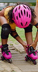 Happy, rollerskate and child in park with shoes for skating, hobby and activity on summer holiday. Outdoor, family and girl prepare with helmet for sports, practice skills and safety on weekend