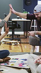 Business, people and high five for creative planning, project or collaboration with design portfolio. Office, group and marketing team with hands together for success, brainstorming or goals on floor