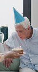 Birthday cake, daughter and surprise old man with hug , house and celebrate milestone in retirement. Senior parent, happy woman and wow with smile for visit, bonding and blow candles in family home