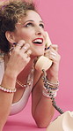Woman, telephone call and laugh in studio with fashion, gossip and funny story on pink background. Girl, happy and retro style in conversation, chat and relax on floor for landline communication