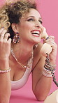 Happy woman, telephone call and laugh in studio with fashion, gossip and story on pink background. Girl, smile and retro style in conversation, funny chat or relax on floor for landline communication