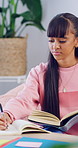 Homework, notes or teenager in house with books, learning activity or preparing essay for assignment. Education, knowledge or girl with writing, quiz answer or textbook review for academic assessment