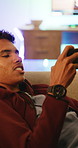 Relax, teenager and boy with mobile for gaming, digital world and interactive site to play online. Phone, entertainment app or child with concentration for virtual contest, competitive battle or home