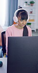 Gaming, computer and girl with headphones in home, virtual contest and play online for entertainment. Digital world, child and teenager with tech for video game competition, typing or internet battle
