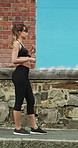 Running, earphones and start with woman in city for streaming service, workout playlist and fitness. Runner podcast, exercise and wellness with female person outdoor for training, music and cardio