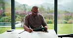 Writing, remote work or black man with tablet in home, accounting audit or review digital records. Tech, compliance inspection or mature auditor with mistake report for feedback, freelance or notes