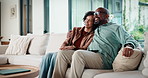 Couple, watching tv and hug on couch with smile, choice and love with streaming in living room. Mature man, woman and embrace with movies, television or film subscription on sofa in lounge at house
