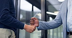 Hands, fist bump and greeting at office with business people, friends or hello with broker. Person, colleagues and respect with handshake, partners and team building in corridor at insurance agency