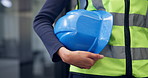 Hands, helmet and engineer on office for construction, safety inspection and reflective vest. Person, technician or architect with gear, ppe or hardhat for property agency project with real estate