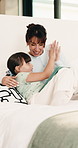 Relax, mom and child in bedroom with tablet for online games, internet or streaming together. Family, home and woman with girl on digital tech for entertainment, videos and bonding on weekend