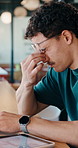 Remote work, tired and man with glasses in cafe, eye strain and deadline stress for project pressure. Fatigue, freelancer and employee with vision problem for planning burnout, eyewear or coffee shop