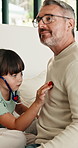 Playing, stethoscope and father with child on bed for bonding, healthcare and fake consultation. Happy, fun and dad with kid for pretend doctor with toy medical equipment in bedroom at house.