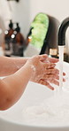Soap, bathroom and child washing hands in home for hygiene, health and wellness with sanitation. Disinfection, basin and kid cleaning skin for dirt, germs or bacteria removal with water in apartment.