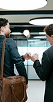 Business, men and happy with fist bump in office for case win, lawsuit settlement or teamwork pride. Back, lawyers and celebration at law firm for legal victory, trial success and career achievement