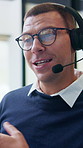 Call center, headset and man with communication, advice or customer support in office. Discussion, consultant or virtual agent in glasses with e commerce service, explain or problem solving for web