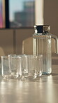 Glass, jar and water on table in office for hospitality refreshment, hydration or service. Boardroom, drink and waiting with h2o in empty workplace for start of work meeting in corporate company