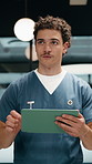 Medical, doctor and man thinking with tablet in clinic for online report, schedule or admin. Nurse, walking and planning with digital tech for healthcare records, treatment or update on surgery