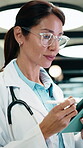 Doctor, tablet and happy woman for healthcare solution, treatment or diagnosis in hospital. Medical, thinking and mature physician with tech for review, reading or good results of clinical report