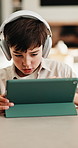 Headphones, tablet and boy for home education, online learning and listening to audio. Digital, tech and child for subscription with virtual lesson, development and interaction on streaming app