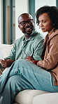 Home, finance and couple with documents on sofa for budget planning, bills and mortgage. Marriage, talking and man with woman on couch for expenses, financial payment and banking account for savings