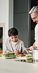 Dad, vegetables and cooking with child in kitchen for meal prep, healthy diet or lunch. Father, kid or helpful son with natural organic ingredients for teaching culinary lesson or hospitality in home