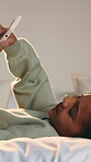 Relax, child and scroll with phone on bed for online videos, social media browsing or weekend break. Smile, girl kid and mobile app in bedroom for internet streaming, message platform or calm in home