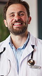 Face, doctor and man with smile for healthcare, wellness and confident for career growth in hospital. Happy person, portrait and pride for health service, medicine and medical professional in USA