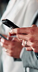 Hands, people and typing with phone in business for contract auction, deal sourcing and IPO. Investment banker, team and mobile app in office to monitor stock prices, online bidding and negotiation
