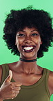 Face, woman and happy in studio with thumbs up emoji, approval or positive feedback for agreement. Black person, hand gesture or like symbol with thank you, smile or satisfaction on green background.
