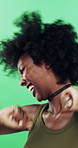 Black woman, happy and dancing in studio with celebration, excited and movement on green background. African person, smile and dancer with rhythm, achievement and laugh for trendy fashion with goals