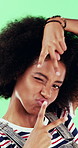 Attitude, edgy and funny face with black woman on green background for emotions or personality. Emoji, facial expression and reaction of person with afro in studio for character transformation