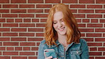 Happy, woman and student with phone by brick wall for networking, social media or email for college. Smile, tech and female person with cellphone for texting or feedback on university application.