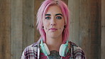 Face, woman and punk fashion by wood background with tattoo, headphones or pink hair for edgy aesthetic. Creative, person and alternative style with audio tech, piercings or makeup for individuality.