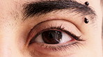 Eye, closeup and optometry with pupil for vision, eyebrow piercing and facial hair with retina. Person, lashes and ophthalmology with eyesight, visual care and stud in skin for body art with portrait