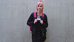 Backpack, fashion and face of student woman outdoor for education, learning or university study. College, pink hair and school with serious pupil on wall background for knowledge or opportunity