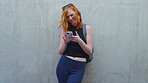 Education, chat and happy woman with phone, outdoor and reading message on social media or browsing. Wall, mockup space and person with smile for communication, thinking and student with mobile app