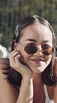 Face, woman and relax with smile outdoor for travel, adventure and holiday abroad. Portrait, female person and sunglasses with happiness, positive attitude and vacation overseas for weekend getaway