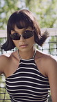 Face, woman and sunglasses outdoor with summer fashion, bob hairstyle and attitude for edgy aesthetic. Serious, female person and Y2K style by net with futuristic shades, confidence or trendy outfit.