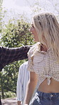 Students, laugh and friends outdoor with fashion, trendy outfit or hug for bonding together at college. Happy, people and walk at university with summer clothes, embrace and casual style for academy.